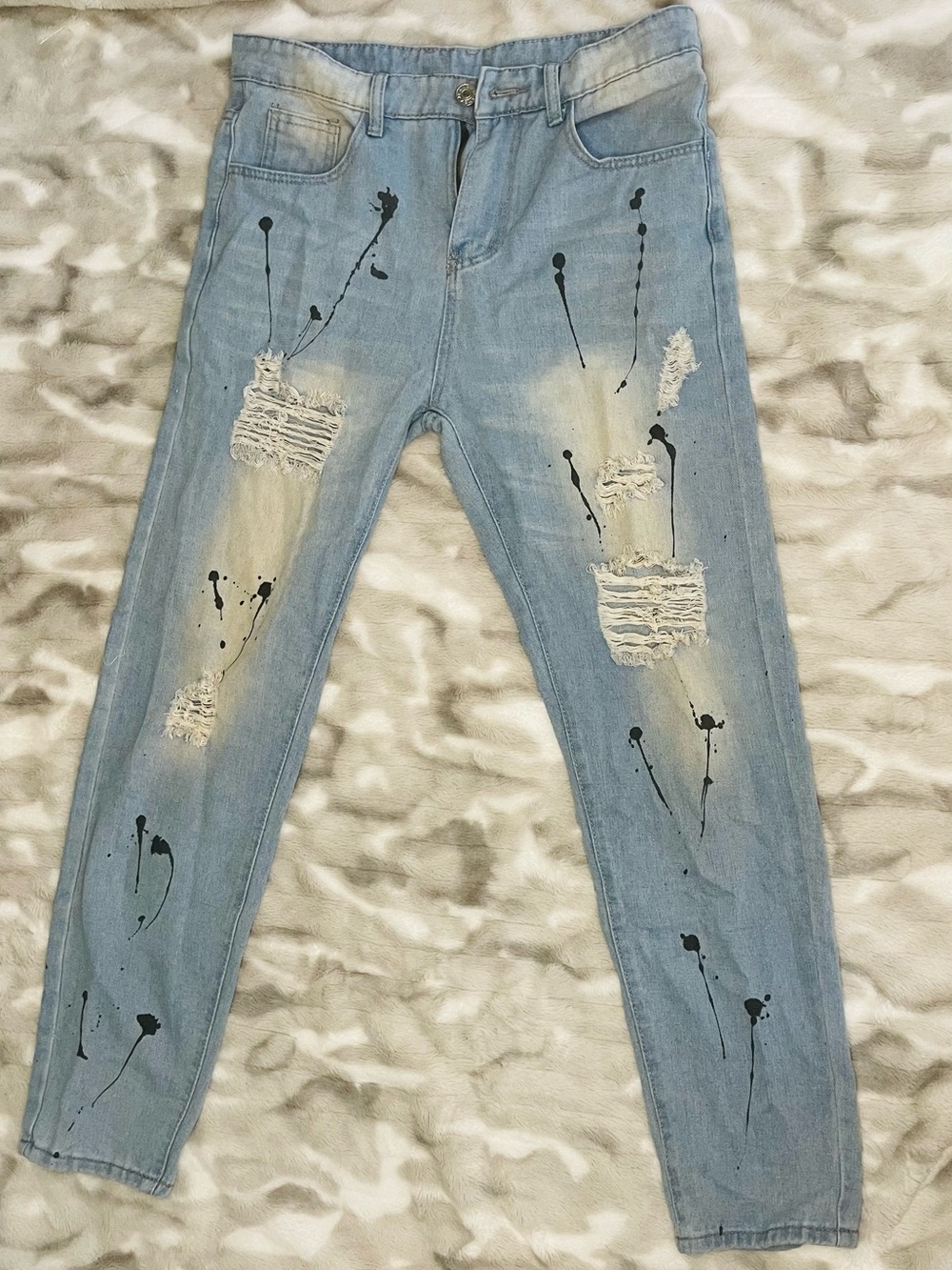 Light Blue Skinny Jeans with Distressed Knees and Black Paint Detail